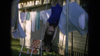 1964: girl swinging upside down from laundry line HAWAII