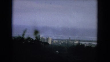 1964: a city is seen with tall buildings along a coastal area HAWAII