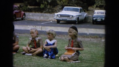 1964: kids learning a lesson outside. HAWAII