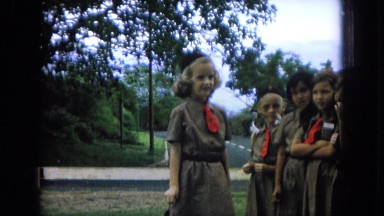 1964: blond girl scout turning to be pinned then showing off her uniform HAWAII