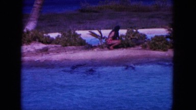 1964: feeding the dolphins in the sea. HAWAII