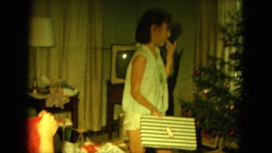 1964: kids busy with decorating the x-mas tree in the room HAWAII