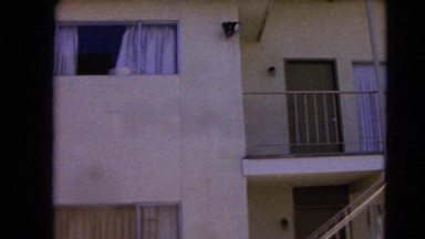 1966: apartment building made of white stone with a staircase BARSTOW