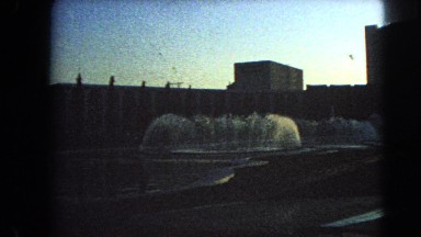 1966: city street view of beautiful water fountain falls on the hotel road side.