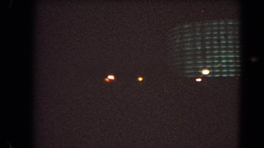 1966: traffic moving through a heavily neon lights decorated part of city