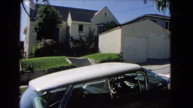 1966: A Man Walking and Posing in a Sunny Residential Neighborhood, Catalina, California