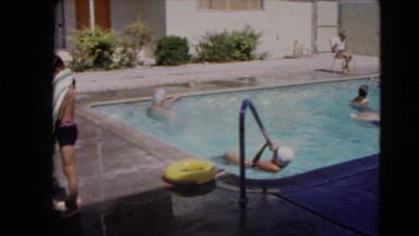 1966: several kids outside playing and swimming in a large swimming pool