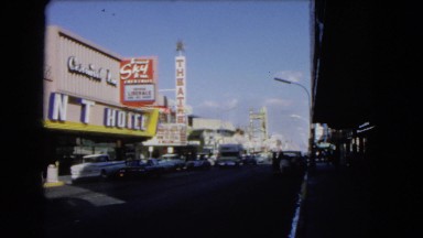 1966: a large hotel with white letters in the city on a busy street CATALINA