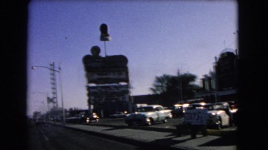 1966: a large sign in a parking lot as seen from a moving vehicle CATALINA