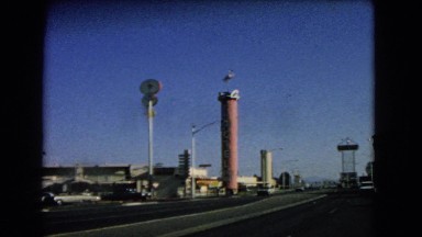 1966: driving down a highway passing various store fronts and inns CATALINA