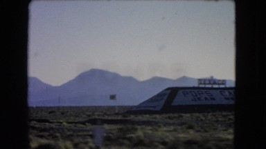1966: traveling on road through flat landscape bordered by mountains. CATALINA