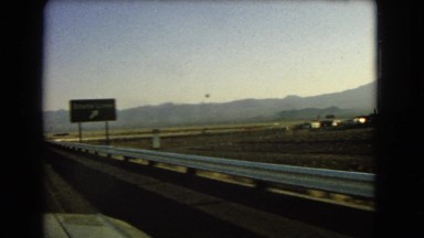 1966: a flat, barren, desolate landscape as seen from a moving vehicle CATALINA