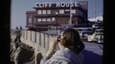 1952: seaside views with a woman looking through binoculars SAN FRANCISCO,
