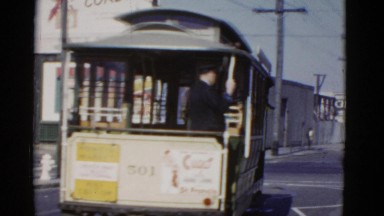 1952: passenger gets down from tram to pick up the fallen item SAN FRANCISCO