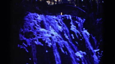 1952: water flows rapidly and steadily down a waterfall to the bottom of a body