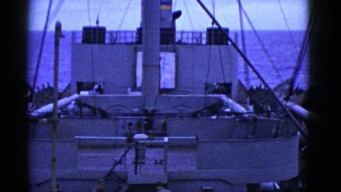 1952: large white vessel with many men anchored in the blue ocean SAN FRANCISCO