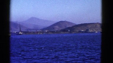 1952: huge boat on the water against a beautiful back drop of our world