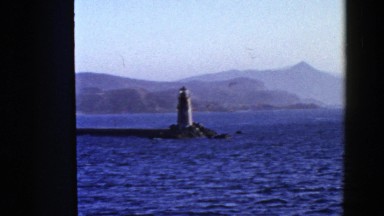 1952: a lighthouse on a inlet surrounded by water and mountains SAN FRANCISCO