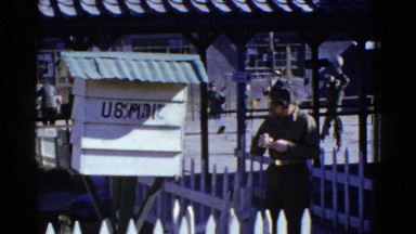 1952: an officer in uniform scribbles something and others are playing