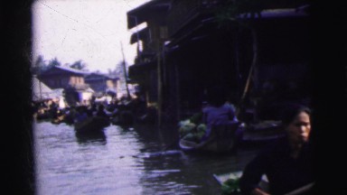 1962: Vendors in Small Boats Row Down Canal Offering Fruits and Vegetables