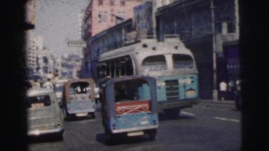 1962: a busy urban street and a hippopotamus in the water at a zoo BANGKOK
