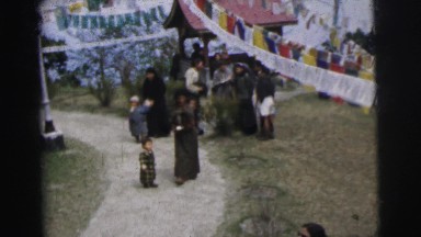 1962: mother carrying baby on her back and walking and a kid follows CALCUTTA