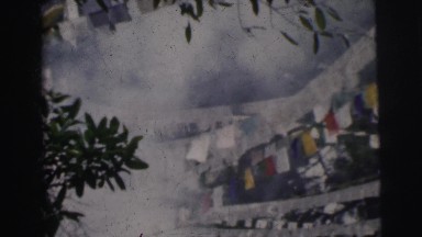 1962: outside recording of a lot of smoke rising between many different banners