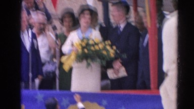 1964: lady on stage accepting bouquet of yellow flowers HARVARD, ILLINOIS