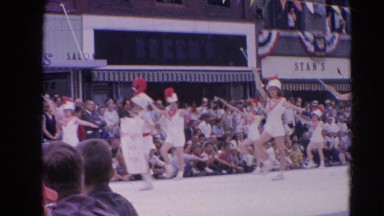 1964: marching pageantry through the street witnessed by many people HARVARD