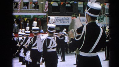 1964: high school marching band playing for people in parade HARVARD, ILLINOIS