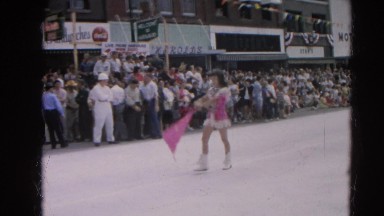 1964: parade baton twirlers flag squad pink girls marching street HARVARD