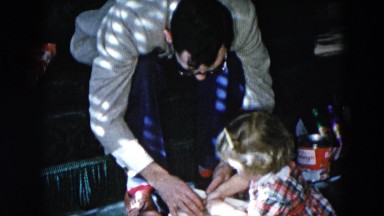 1956: a father with child is seen near a christmas tree HICKSVILLE, NEWYORK
