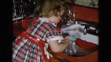 1956: daughter helping mom in the kitchen washing dishes. HICKSVILLE, NEWYORK
