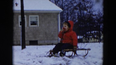 1956: child getting ready to go sledding HICKSVILLE, NEW YORK