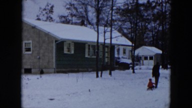 1956: father and son playing in the snow HICKSVILLE, NEW YORK
