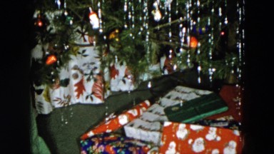 1956: a christmas tree is seen with a child opening presents HICKSVILLE, NEWYORK