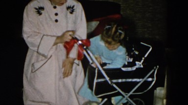 1956: little girl playing with her stroller with her mother HICKSVILLE, NEW YORK
