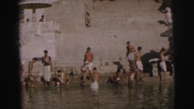 1962: people are seen bathing in some ritual or so and a boat seem passing by