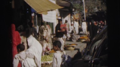 1962: a busy street with people shopping and vendors showing their wares
