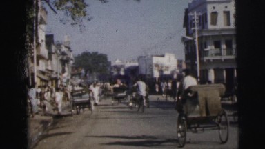 1962: busy street with cyclists, pedestrians, buses, rickshaws etc DARJEELING