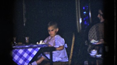 1951: a cute baby girl is sitting in the dinning table chair and watching