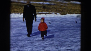 1956: toddler walks on the snow on a cold winter day. HICKSVILLE, NEW YORK