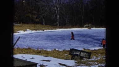 1956: children are skating in frozen lake in the forest HICKSVILLE, NEW YORK