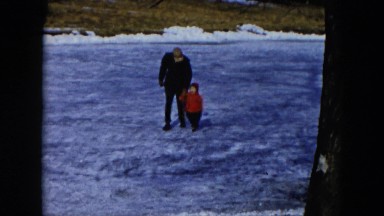 1956: a toddler with grandfather walking across the lake HICKSVILLE, NEW YORK