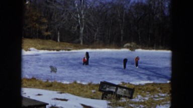 1956: children are skating in frozen lake in the forest HICKSVILLE, NEW YORK