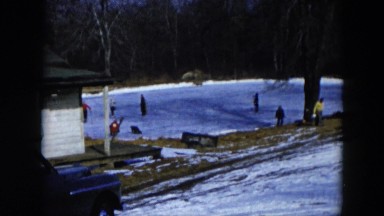 1956: children are skating in frozen lake in the forest HICKSVILLE, NEW YORK