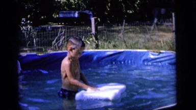 1964: Boy Playing With Floating Pad In Pool, Camden, New Jersey