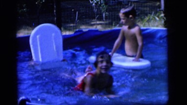1964: children play with floats in backyard pool CAMDEN NEW JERSEY