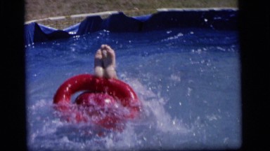 1964: boy holding nose while going underwater in small pool CAMDEN NEW JERSEY