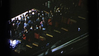 1964: people standing in line at an amusement park waiting to get on a ride